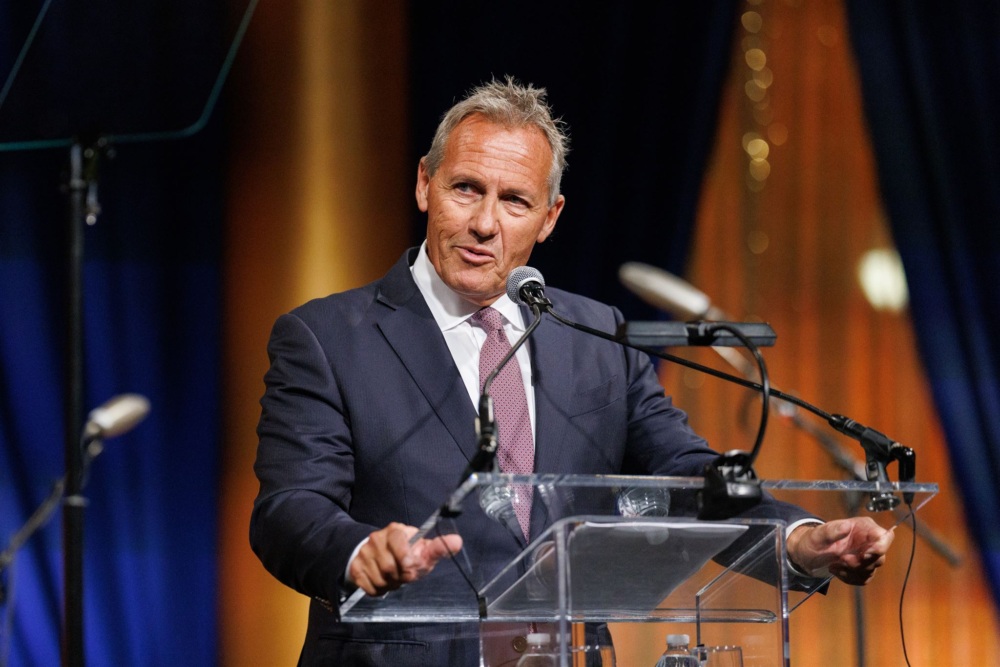 Emerald sponsor of the 2025 Annual Gala, Kevin Bebee, speaks during the main program about his wife Cortney.